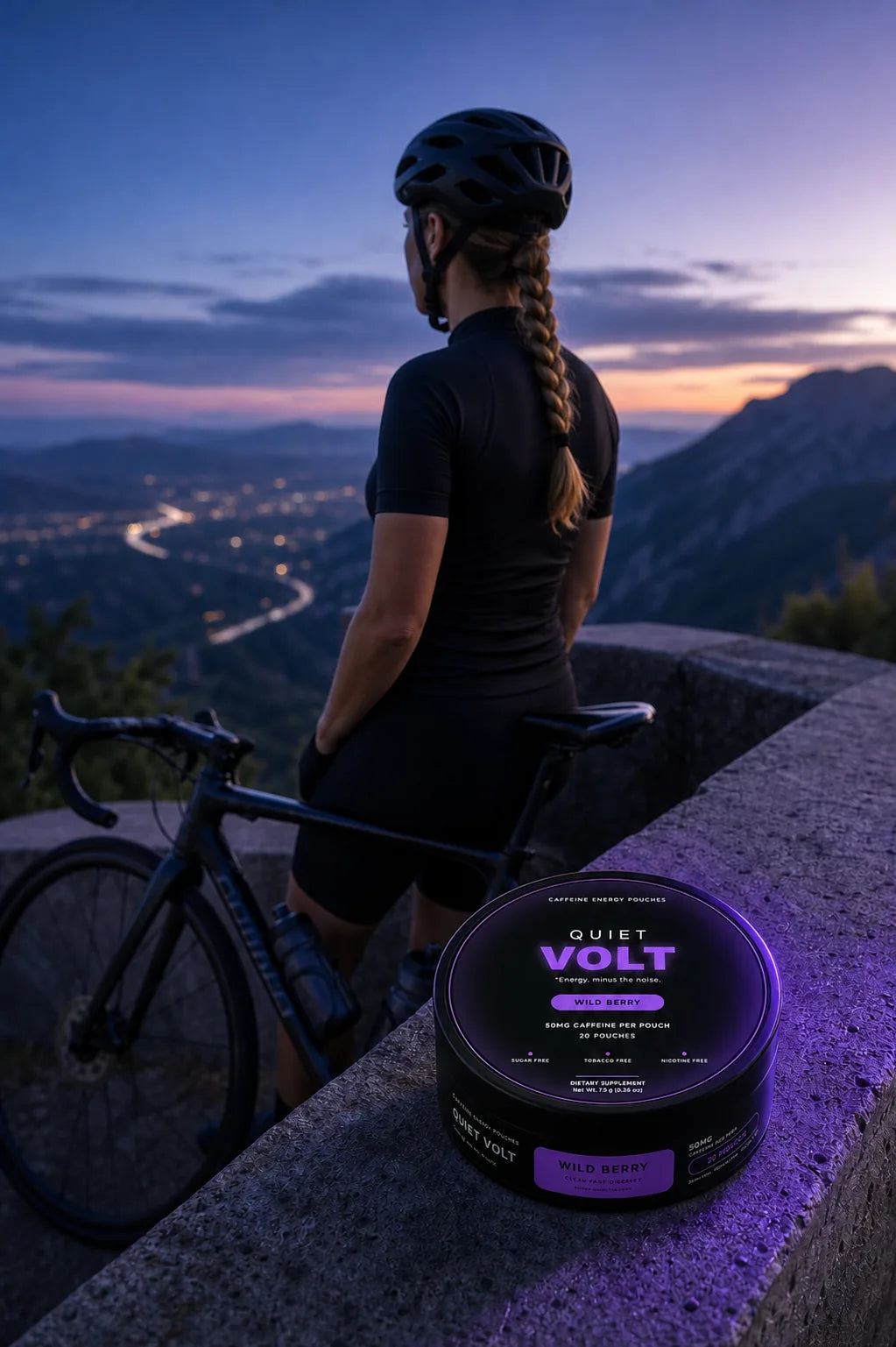 Adult woman cyclist at a mountain overlook beside a QUIET VOLT Wild Berry caffeine pouch can